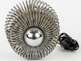 a metal object that is sitting on a white surface