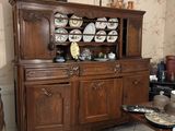 a wooden china cabinet in the corner of a room