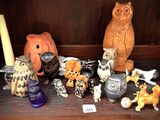 many figurines of animals on a shelf in a room
