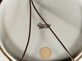 a close up of a plate with a gold rim