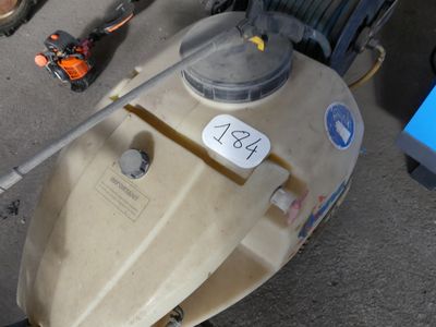 a small boat sitting on the ground with a sticker on it