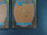 pair of magic the gathering deck cards on a black surface