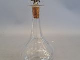 a small glass bottle with a cork stopper on it