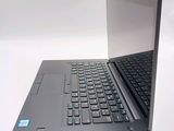 a laptop computer sitting open on a white surface