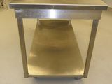 a stainless steel table in the middle of a kitchen
