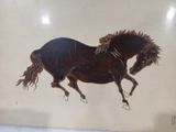 a picture of a painting of a horse on the wall