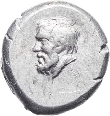 a close up of a coin with a man ' s face on it