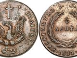 a close up of a coin with a cross on it