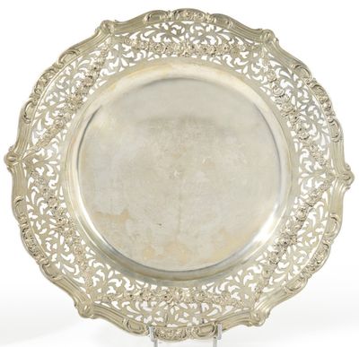 a silver plate on a stand on a white background