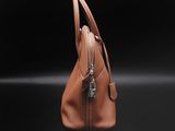 a brown handbag on a black background