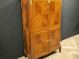a wooden cabinet with a door and a drawer on top of it