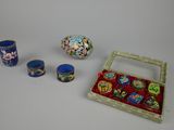 a small box with three cups and a vase on the table