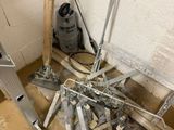 a pile of tools sitting on the floor next to a wall