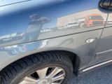 a reflection of a man on the side of a car