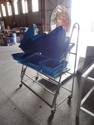 a blue shopping cart with two blue umbrellas on it