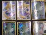 a lot of pokemon cards that are on the table