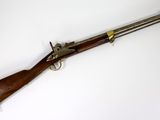 a rifle with a wooden barrel and brass fittings on a white background