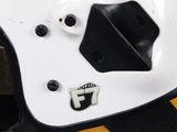 a close up of a white helmet with a yellow and black stripe