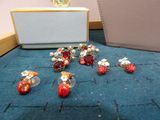 a lot of red and gold earrings sitting on the floor next to a purse