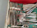 a lot of silverware in a box on a table