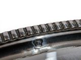 a close up of a silver plate with a hole in it