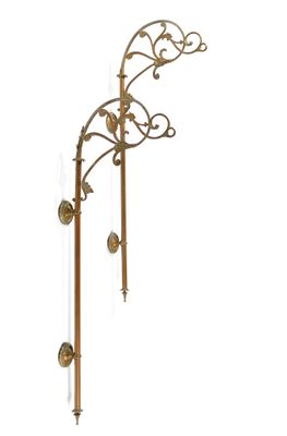 brass wall sconce with two candles on each side of it