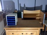 a wooden dresser with drawers and a microwave on top of it