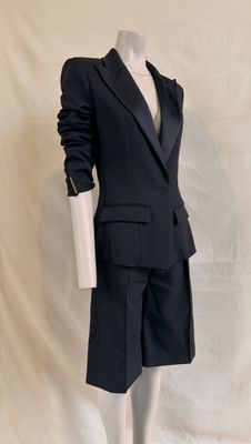 a mannequin wearing a suit and tie on a mannequin stand