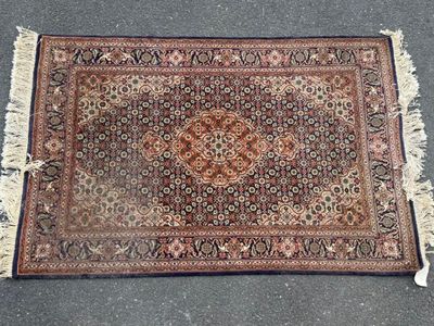 a close up of a rug with fringes on the ground
