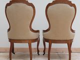 pair of antique chairs with upholstered back and arms