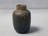 a small vase that has a crack in it