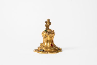 an antique brass figurine of a woman with a crown on her head