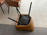a suitcase with two umbrellas in it on the floor