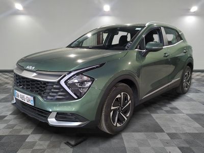 the green suv is parked on a checkered floor in a garage