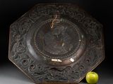 a plate with a picture of a woman on it next to an apple