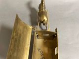 brass figurine of a horse and rider in a box on a white background