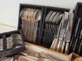 a lot of silverware in a box on the table