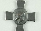 a silver medal with a picture of a man on it