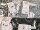 several pairs of men ' s clothing are wrapped in plastic bags