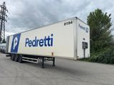 a semi trailer parked in a parking lot with trees in the background