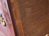 a close up of a wooden bench with a bunch of nuts on it