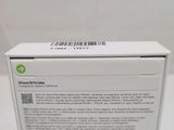 the back of a white box with a green sticker on the side of it