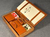 a small wooden box with a card game inside of it