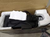 a box with a laptop and a charger inside of it