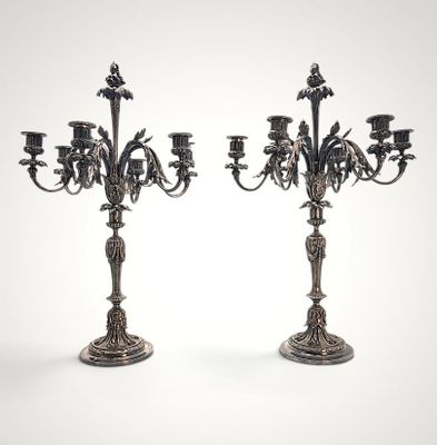 pair of antique silver candelabs with flowers and leaves