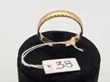 a close up of a gold ring on a black ring holder