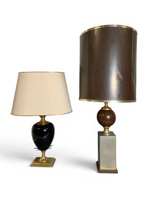 two lamps on a table with a lamp shade on top of them