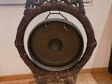 a gong on a stand in front of a window