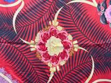 a close up of a red and black floral print fabric