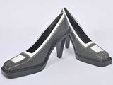 pair of black and white high heel shoes on a white surface